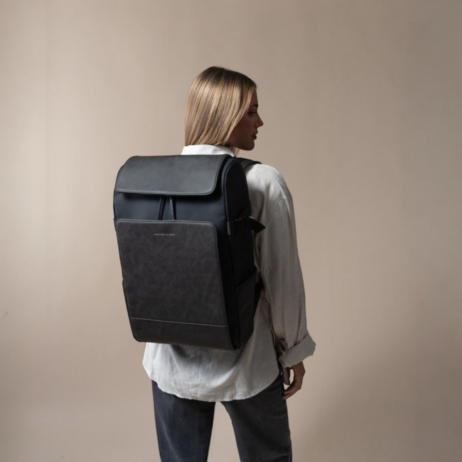 Lieblingstasche Bali Pro black backpack with faux leather accents worn by a woman.