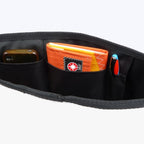 Lieblingstasche Barkasse bag interior featuring black nylon organizer pockets with a phone, wallet, and pen