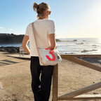 Lieblingstasche Barkasse Mini messenger bag in light grey with a large red number 3 graphic and orange trim.