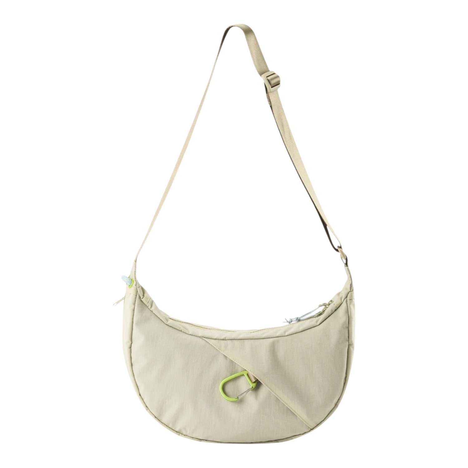 Lieblingstasche beige crescent-shaped sling bag with an adjustable strap and a bright green carabiner detail.