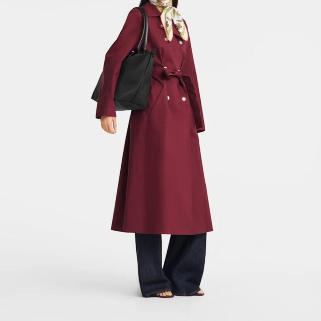 Lieblingstasche black nylon tote bag with leather handles, worn by a woman in a burgundy trench coat.