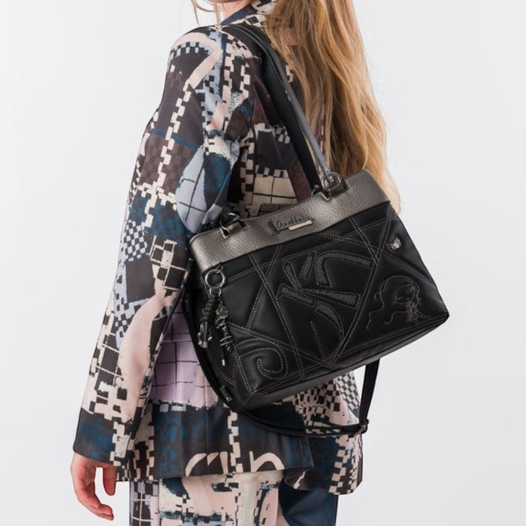 Lieblingstasche black shoulder bag with metallic silver trim and decorative stitching worn over the shoulder