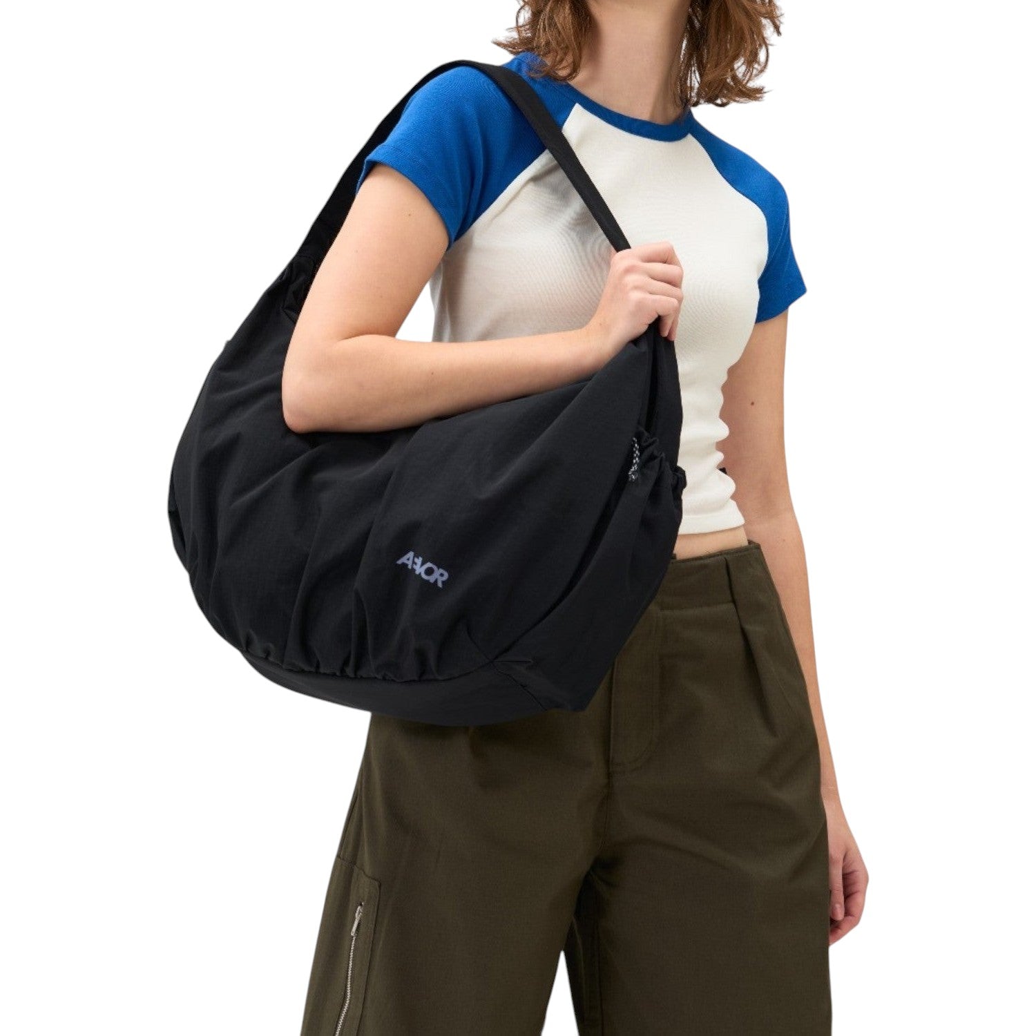 Lieblingstasche black slouchy shoulder bag worn by a woman against a white background