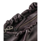 Close-up of the Lieblingstasche Bloom handbag in dark purple leather with a gathered ruched top and zipper closure.