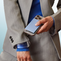Lieblingstasche blue fluted MagSafe card protector attached to a smartphone held by a person in a grey suit