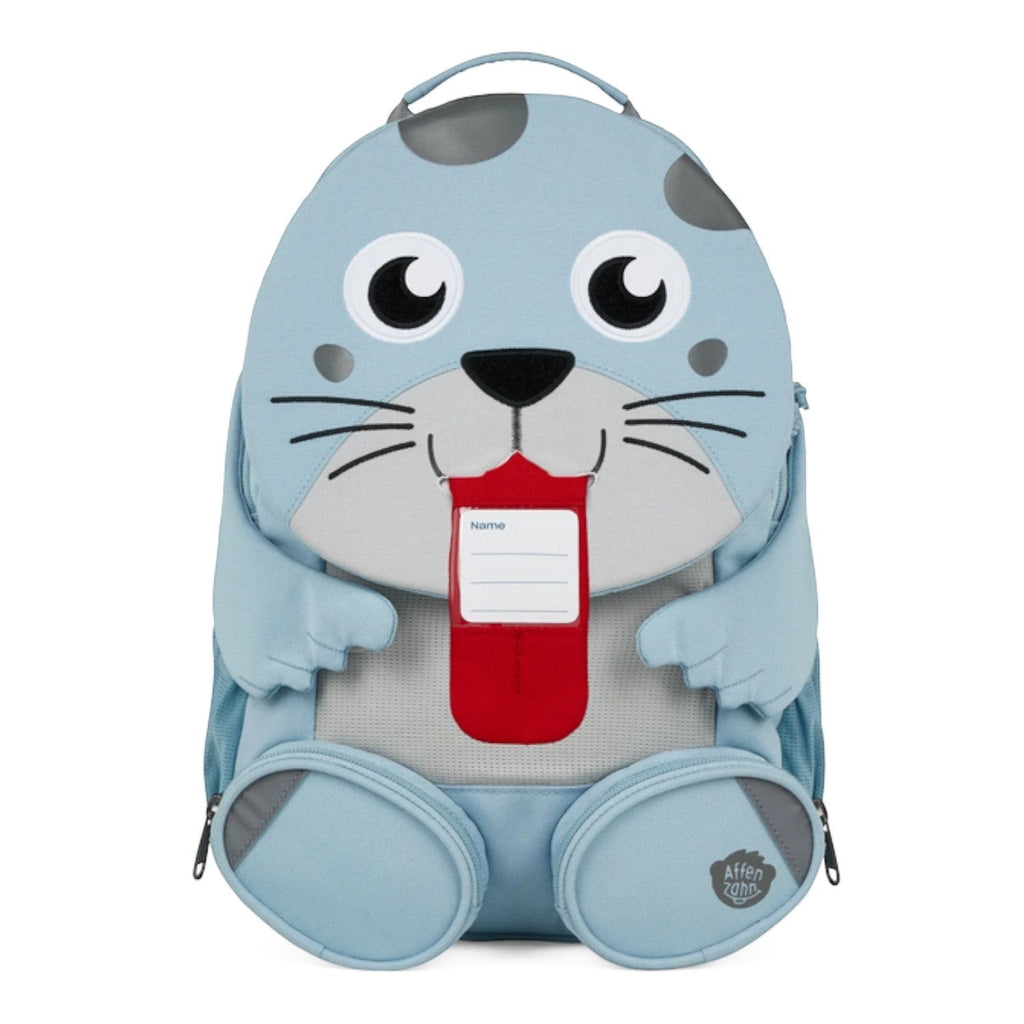 Lieblingstasche blue seal backpack with cute face, red tongue, and name tag. Features padded straps and zippered pockets.