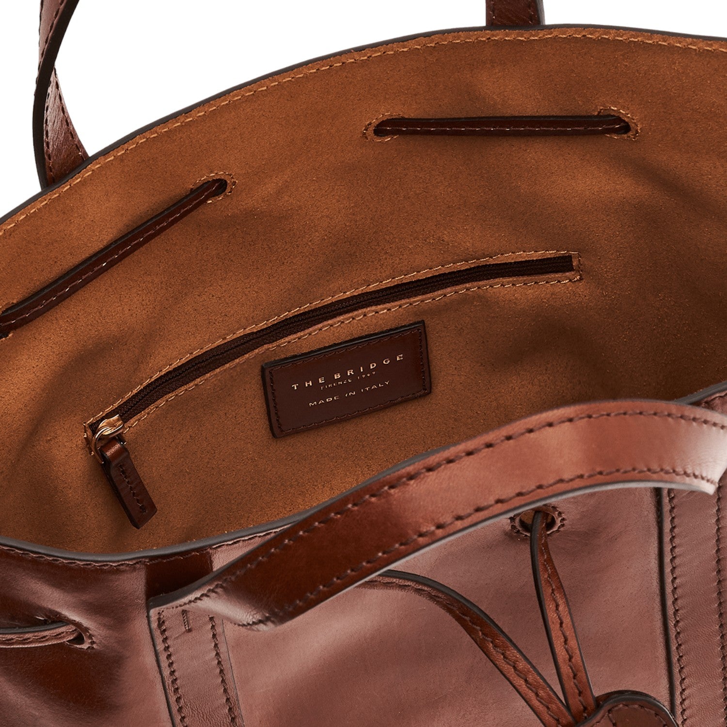 Lieblingstasche brown leather drawstring bucket bag with interior zip pocket and leather logo patch.
