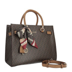 Lieblingstasche Tote M in brown with monogram pattern, braided handles, and a decorative patterned silk scarf.