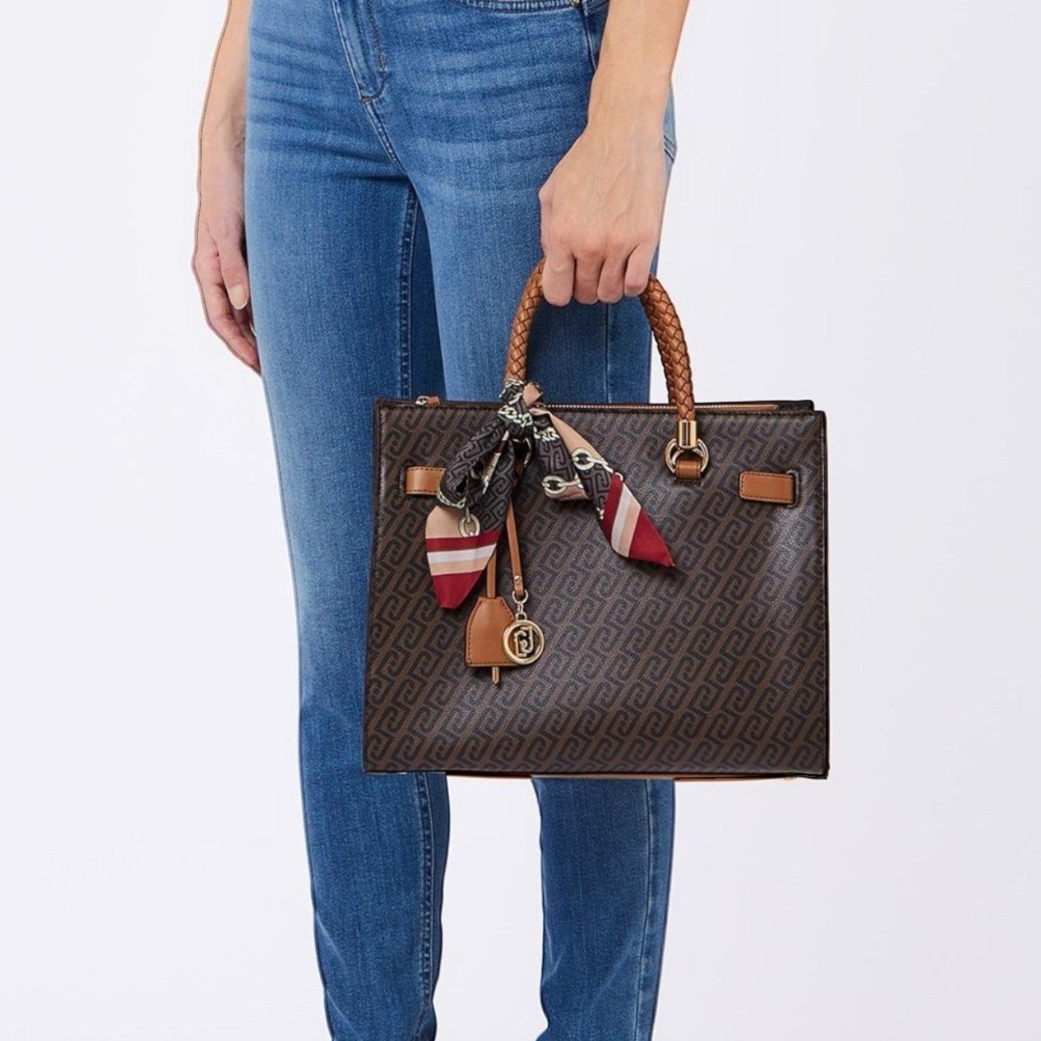 Lieblingstasche Tote M brown monogram handbag with braided handles, gold charm, and a decorative patterned scarf.