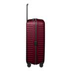 Lieblingstasche UPGRADE 4w Trolley L in deep burgundy with a ribbed hard shell and four wheels, side view.