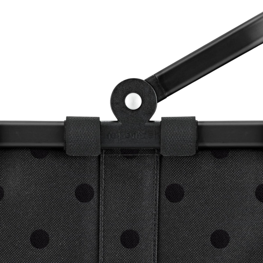 Lieblingstasche Carrybag XS in black with a subtle polka dot pattern and a sturdy black folding handle