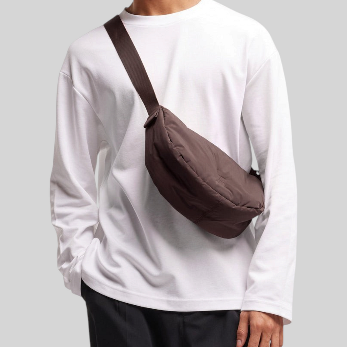 Lieblingstasche Cloud Moon Bag Small in dark brown worn as a crossbody bag by a man in a white long-sleeve shirt