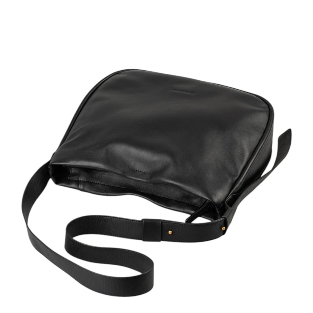 Lieblingstasche Coral black leather shoulder bag with a minimalist design and adjustable strap on a white background