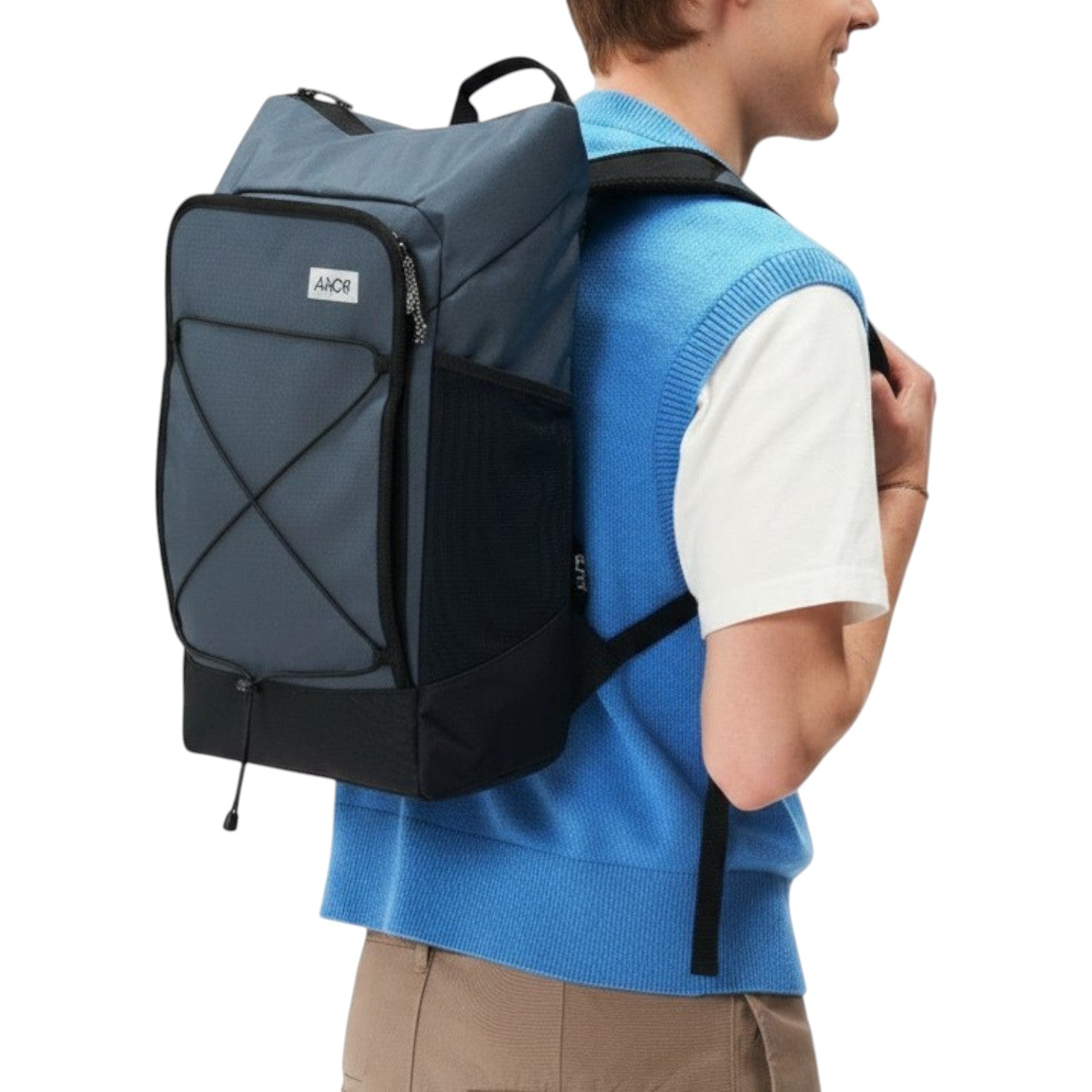 Lieblingstasche Day Pack FLX in blue and black with front bungee cord and mesh side pockets worn by a model