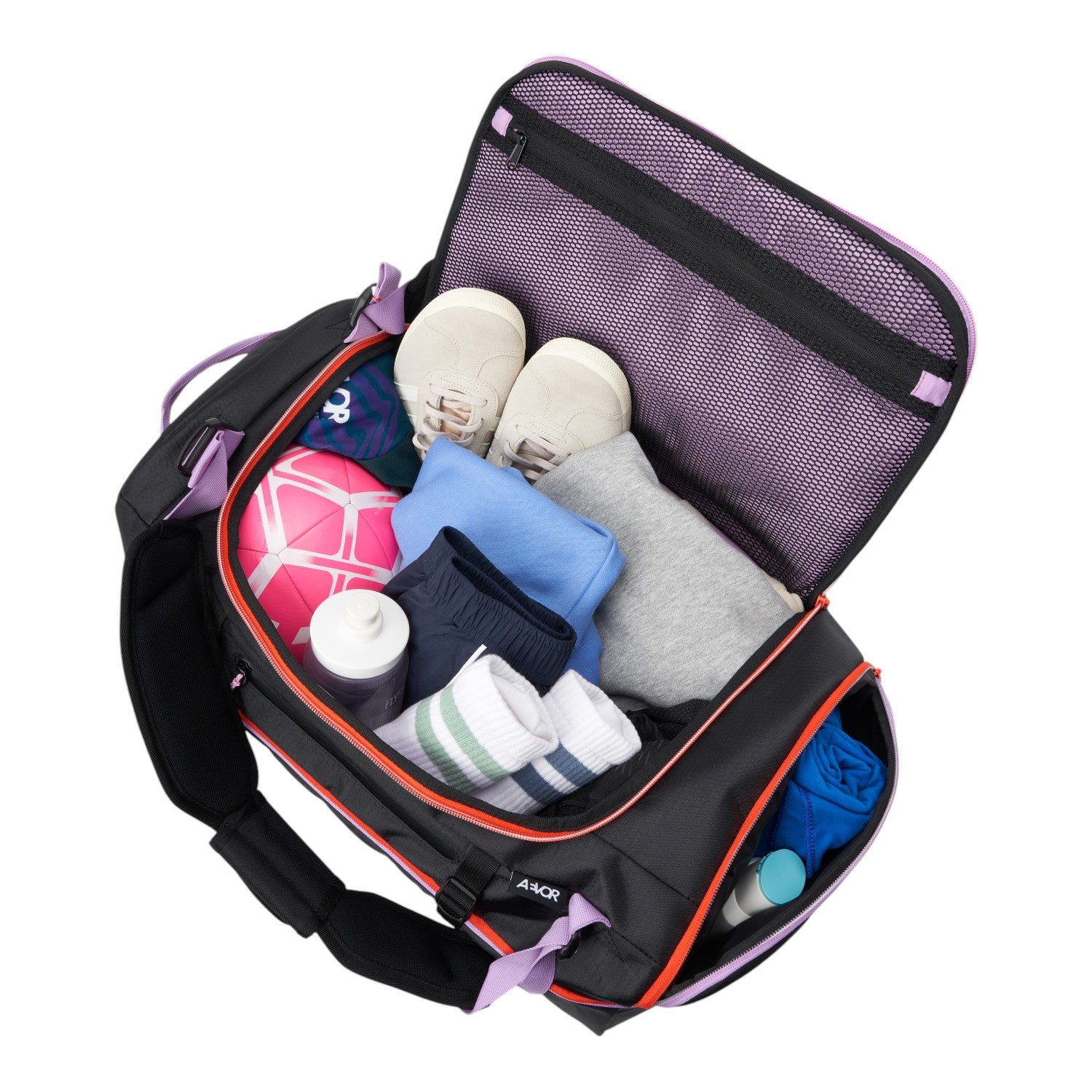 Lieblingstasche Duffel Pack open with packed clothes, shoes, and sports gear, featuring black fabric and purple trim.