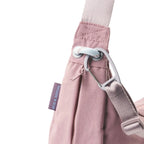Lieblingstasche dusty pink sling bag with a carabiner clip, adjustable strap, and Eco & Social side label.