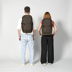 Lieblingstasche Easy27 brown everyday backpack worn by a man and a woman, showing back view and padded straps.