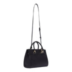 Lieblingstasche ECS Satchel S in black leather with braided top handles and gold hardware on a light background