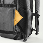 Lieblingstasche eoto Easy27 grey backpack with a yellow wallet in the side pocket, featuring durable recycled fabric.