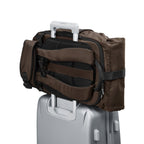 Lieblingstasche eoto Tall41 brown rolltop travel backpack with trolley sleeve attached to a silver suitcase