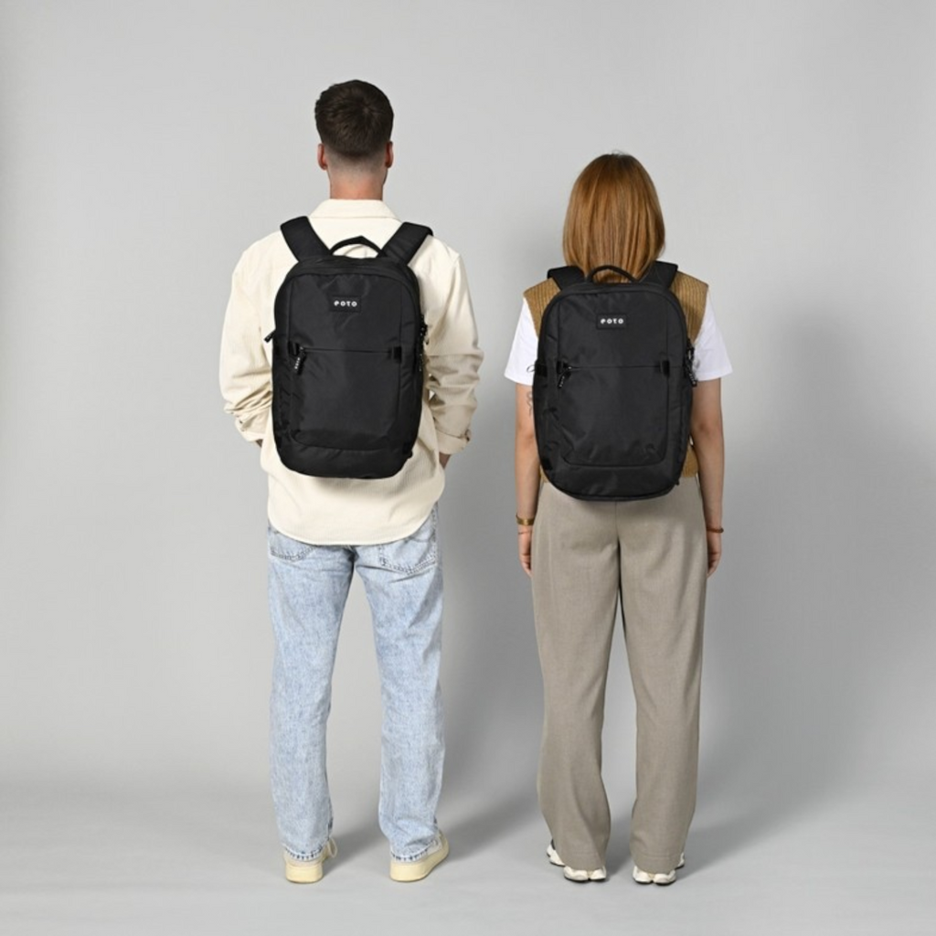 Lieblingstasche eoto Tidy22 black minimalist business backpack worn by a man and a woman against a grey background