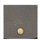 Lieblingstasche Epure grey leather handbag close-up with gold button detail and embossed logo