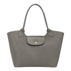 Lieblingstasche Epure Schultertasche L in grey grained leather with a gold-tone snap button closure.