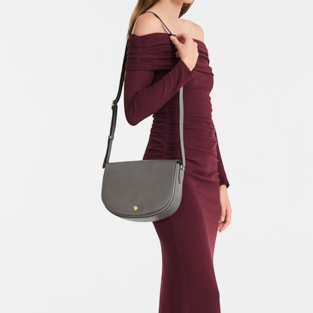Lieblingstasche Epure M grey leather crossbody bag with gold hardware and adjustable strap.