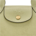 Lieblingstasche Epure XS light green textured leather crossbody bag with gold hardware and embossed logo.