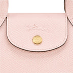 Lieblingstasche Epure XS light pink textured leather crossbody bag with embossed horse logo and gold hardware.