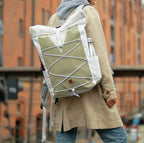 Lieblingstasche Fjord backpack in olive green and white canvas with a bungee cord front and side water bottle pocket.