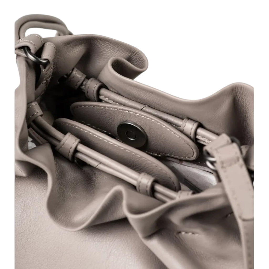 Interior view of the Lieblingstasche Fleur taupe leather bucket bag featuring a magnetic snap closure and drawstring detail