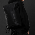 Lieblingstasche a/u by aunts & uncles Fukui black rolltop backpack with water-repellent coated canvas on a model