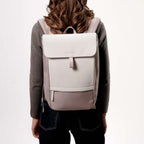 Lieblingstasche Kapten & Son Fyn backpack in beige with minimalist design, worn by a woman from the back view.