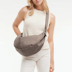 Lieblingstasche GOT BAG Moon Bag Large in taupe worn crossbody by a woman in a white top