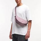 Lieblingstasche GOT BAG Moon Bag Small in dusty purple worn crossbody by a man in a white t-shirt