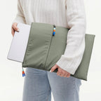 Lieblingstasche GOT BAG olive green removable laptop sleeve with zipper and colorful pull tabs held by a person
