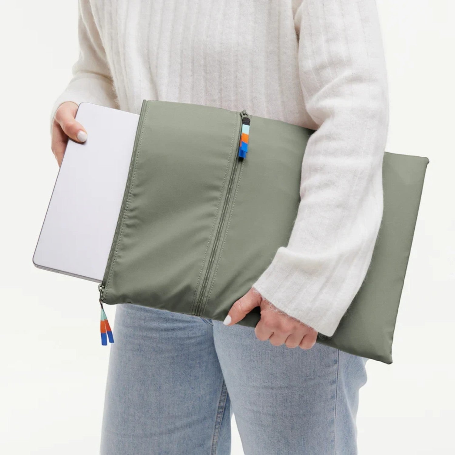 Lieblingstasche GOT BAG olive green removable laptop sleeve with zipper and colorful pull tabs held by a person