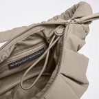 Lieblingstasche GOT BAG Pleat Moon Bag Small in beige, showing the interior zipper compartment and recycled material tag