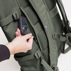 Lieblingstasche GOT BAG Rolltop 2.0 backpack in olive green with a hand accessing the back security pocket