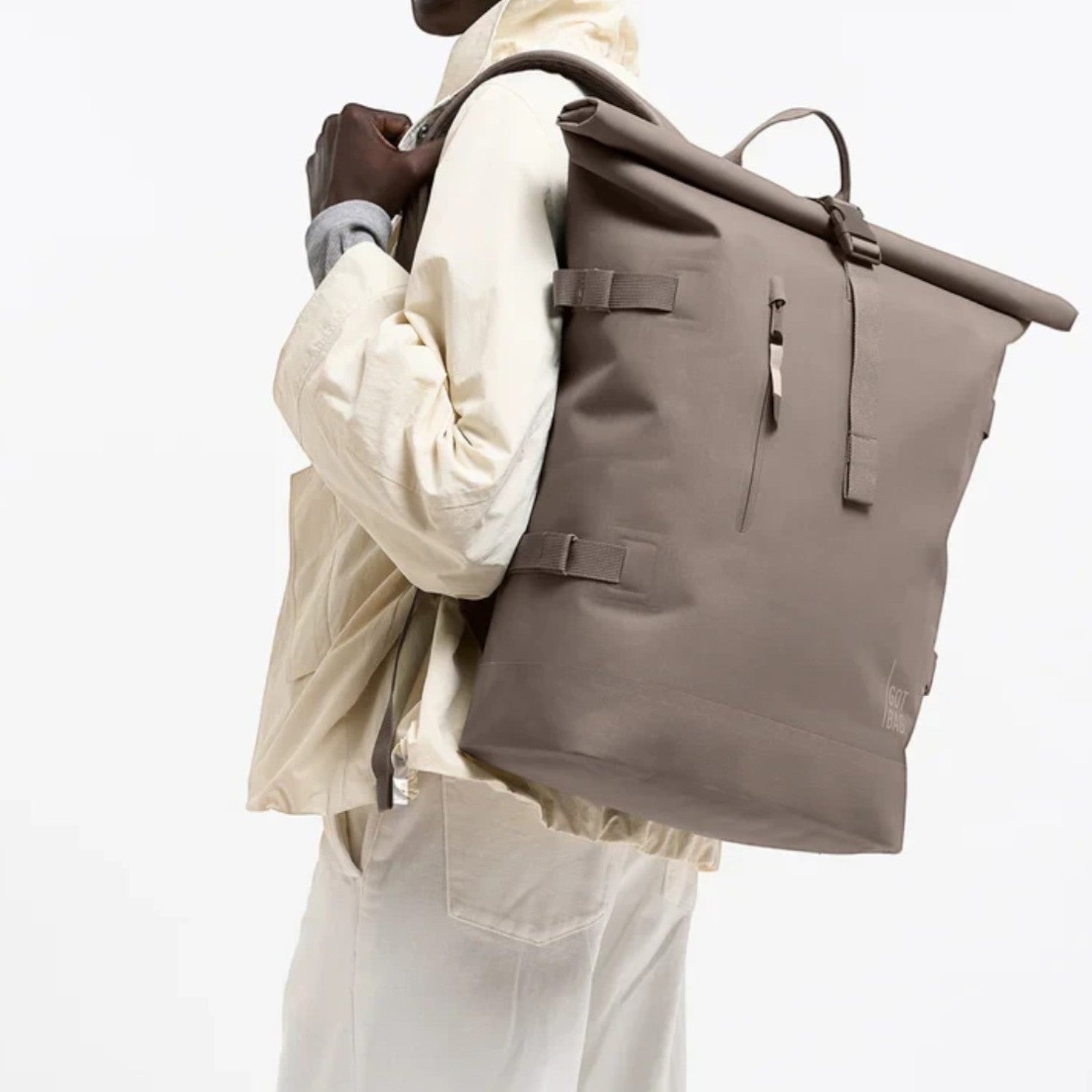 Lieblingstasche GOT BAG Rolltop 2.0 backpack in taupe worn by a smiling model against a white background