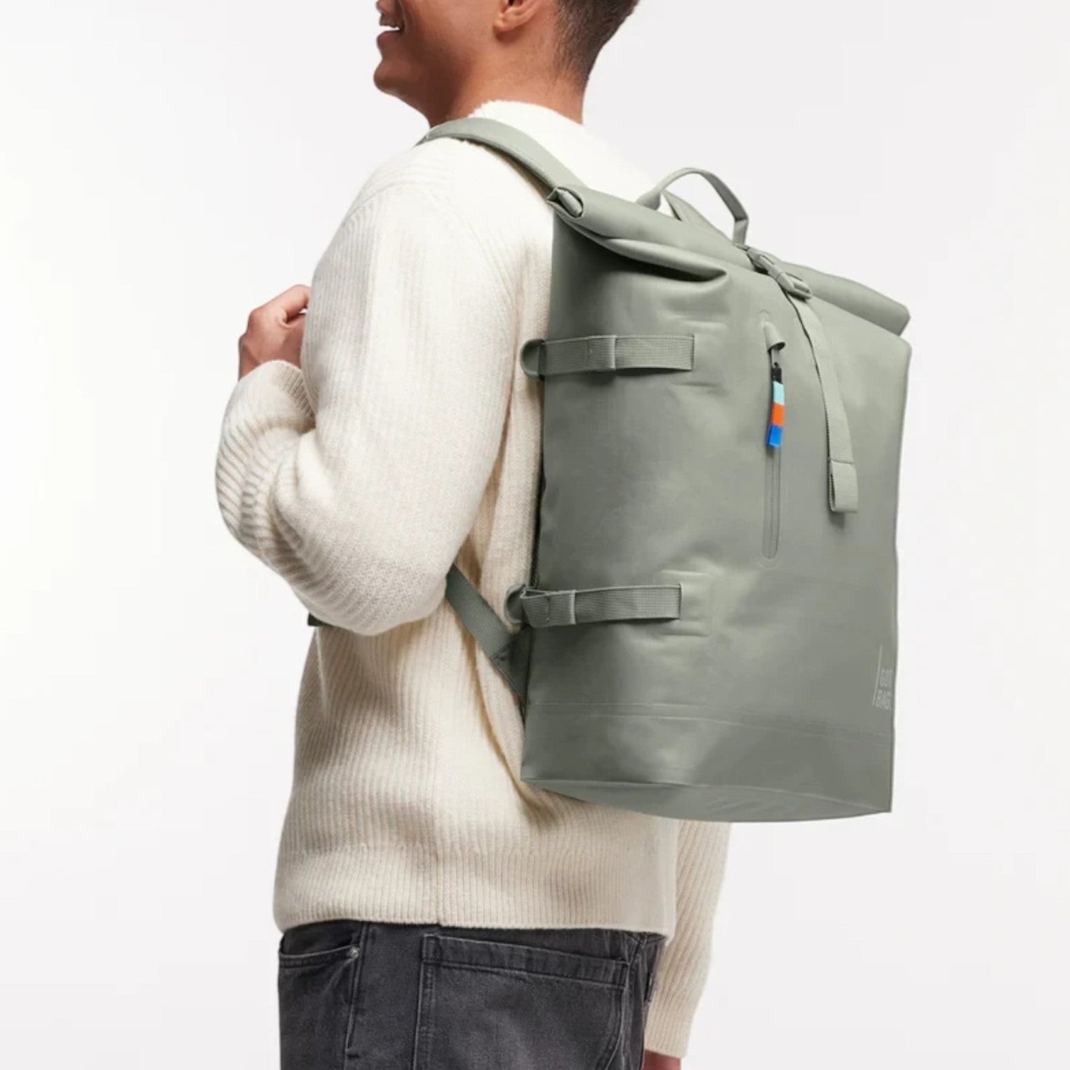 Lieblingstasche GOT BAG Rolltop 2.0 backpack in sage green worn by a man against a white background