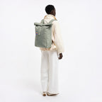 Lieblingstasche GOT BAG Rolltop Easy backpack in sage green worn by a model against a white background