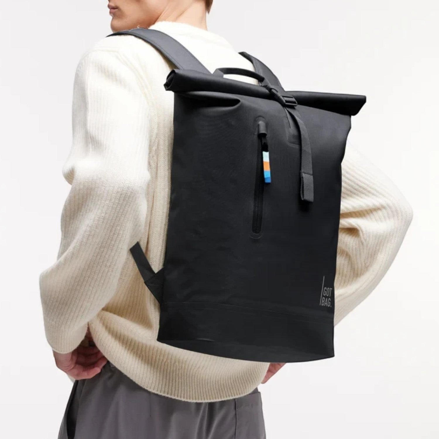 Lieblingstasche GOT BAG Rolltop Lite 2.0 black waterproof backpack worn by a man in a white sweater