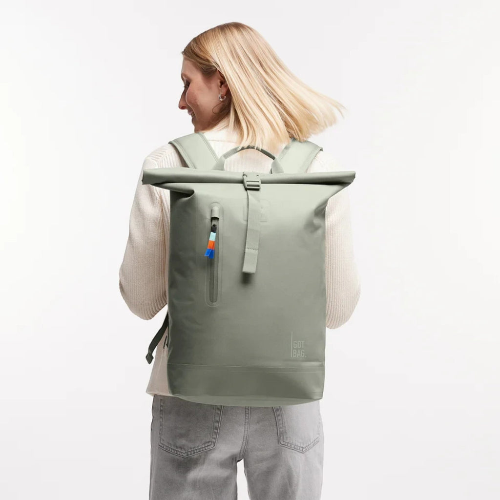 Lieblingstasche GOT BAG Rolltop Lite 2.0 sage green waterproof backpack worn by a woman with adjustable straps