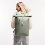 Lieblingstasche GOT BAG Rolltop Lite 2.0 sage green waterproof backpack worn by a woman with adjustable straps