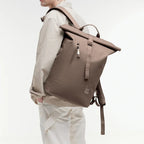 Lieblingstasche GOT BAG Rolltop Lite 2.0 backpack in taupe worn by a man against a white background