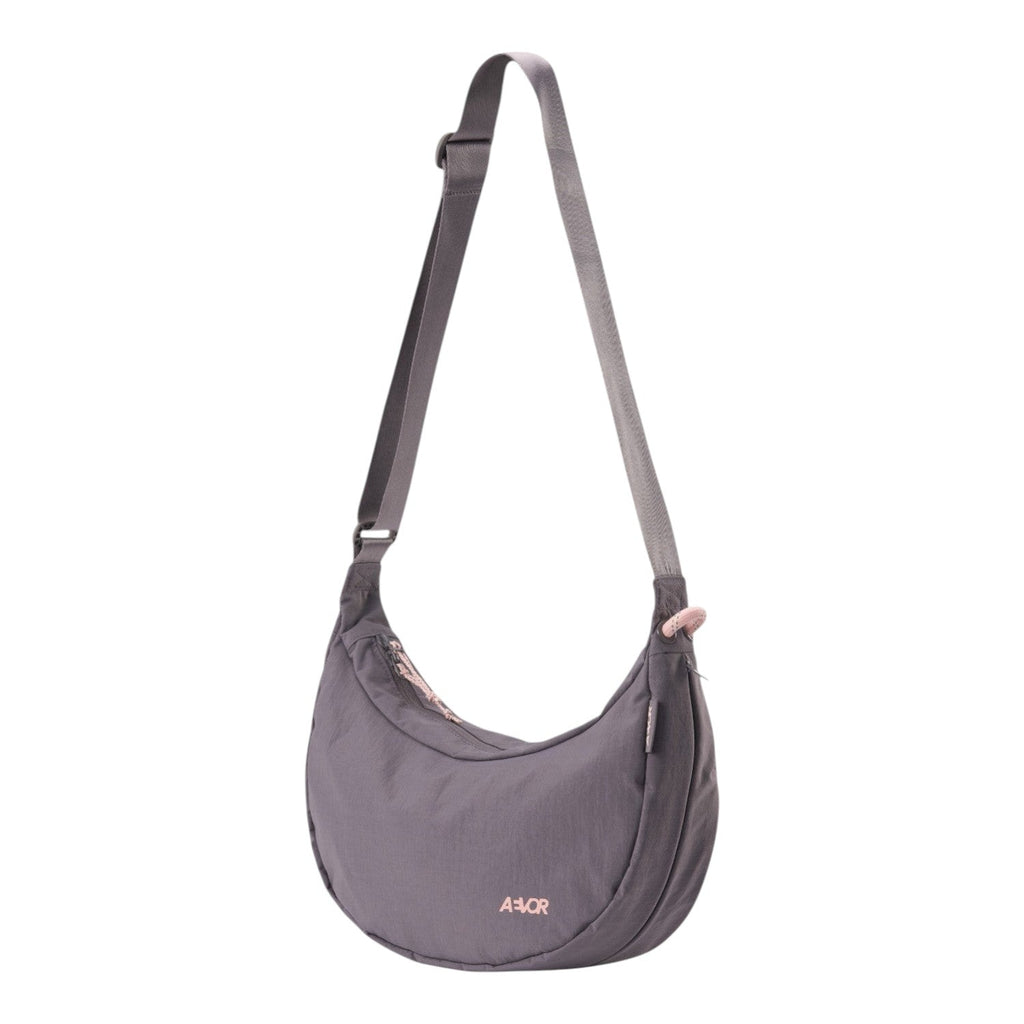 Lieblingstasche grey crescent-shaped sling bag with adjustable shoulder strap and pink zipper details