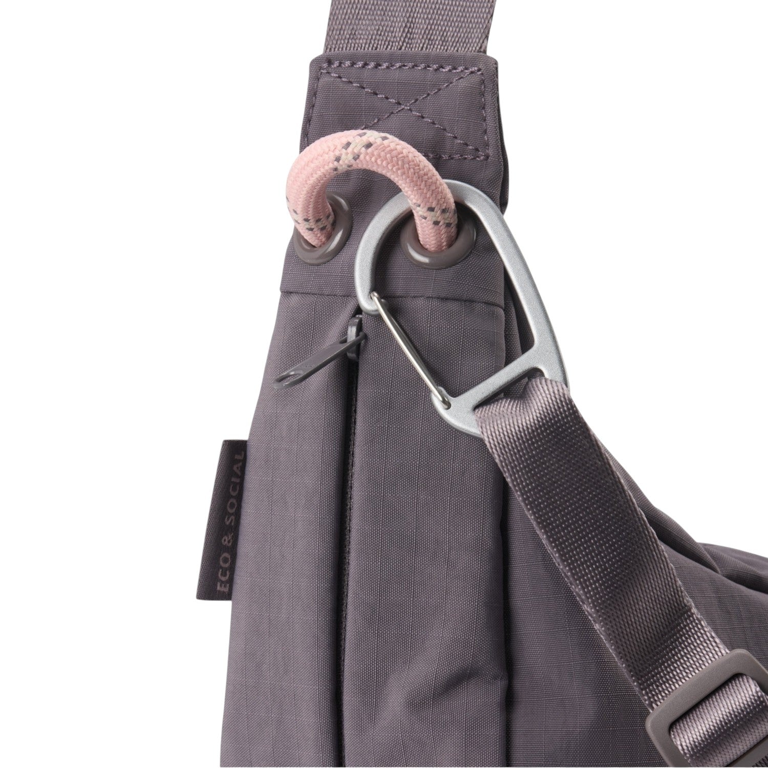 Lieblingstasche sling bag in grey with a pink rope detail, silver carabiner, and Eco & Social side label