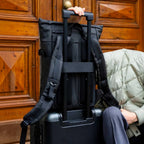 Lieblingstasche Helsinki Pro black backpack with luggage strap attached to a suitcase handle